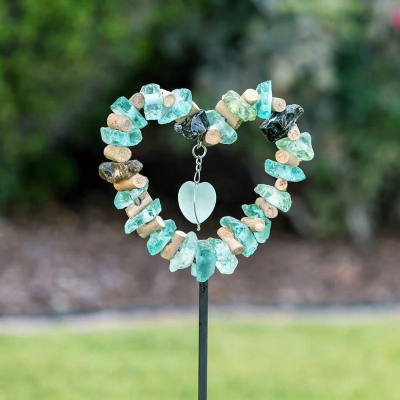 A garden decoration made of sea glass in the shape of a heart