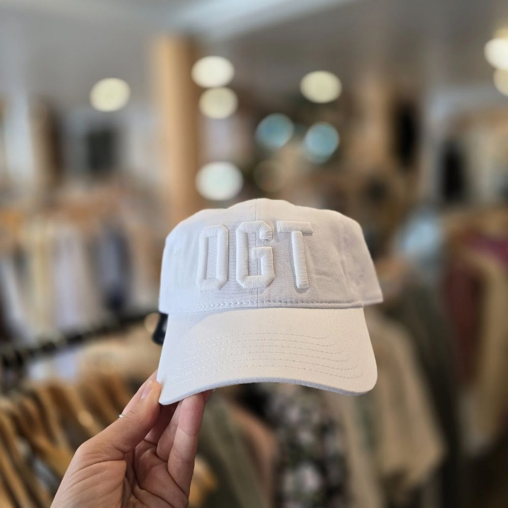 A white baseball cap with white lettering that says "OGT"